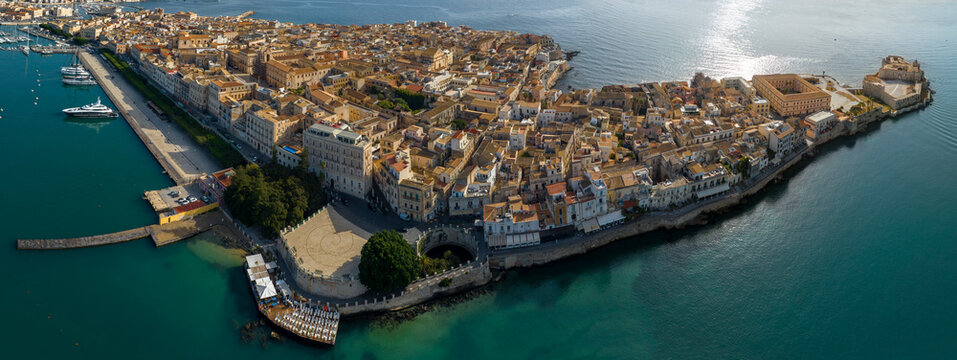 Panoramic aerial view of the island of Ortygia. This is the location of the historic center of Syracuse, Sicily, Italy. The city overlooks the Mediterranean Sea and contains many historical landmarks.