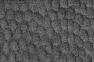 Textured gray wooden surface with carved oval patterns and visible wood grain. Abstract texture...