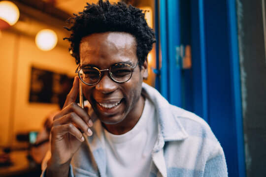 Focused young man gesturing with a digital stylus while looking at a tablet, demonstrating concentration, digital interaction, and the integration of technology into creative or work life.