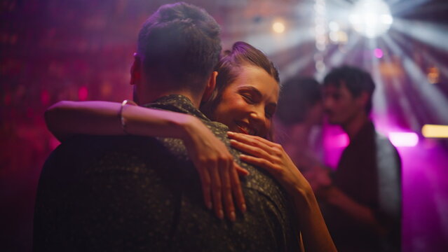 Affectionate pair dancing club enjoying intimate moments closeup. Smiling lovers