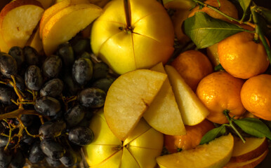 Fresh fruits, top view of sliced ​​apples, grapes, and tangerines