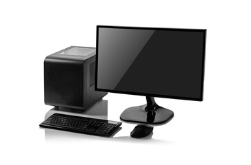 A black desktop computer with a small form factor tower, a flat-screen monitor, a keyboard, and a mouse is isolated on a reflective white background.