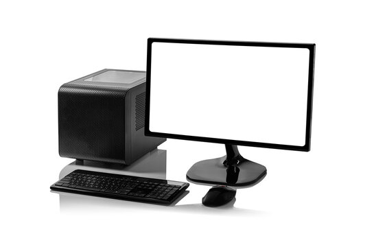 A black desktop computer setup, including a small form factor tower, a monitor with a blank white screen, a keyboard, and a mouse, is isolated on a white background with a reflective surface.