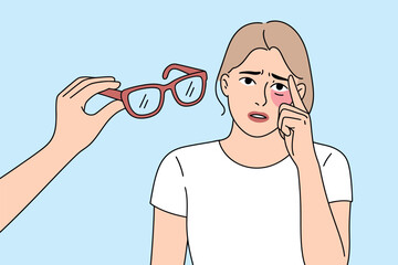 A person offers eyeglasses to a woman with a bruised eye, suggesting a need for vision correction or recovery from an injury.