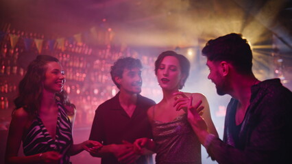Cheerful group clubbing night club having fun together closeup. Smiling friends