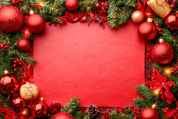 Bright holiday decorations with red ornaments, green pine branches, and red flowers create a cheerful festive border for seasonal events