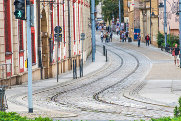 European cobbled street with tram tracks and pedestrian crossing signal