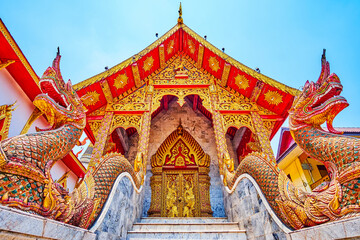 Naga serpents and gilt facade of Ubosot in Wat Thung Yu, Chiang Mai, Thailand