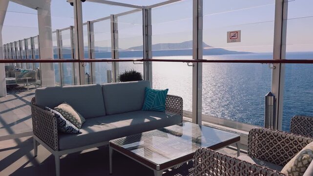 Open deck with cushioned seating glass railing bright sky clean surfaces minimal design and calm spacious atmosphere.