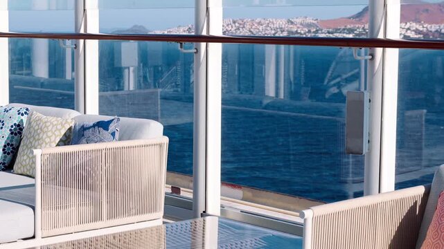 Open deck with cushioned seating glass railing bright sky clean surfaces minimal design and calm spacious atmosphere.