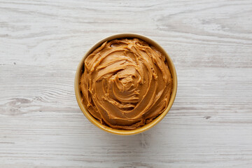 Creamy Brown Peanut Butter in a Bowl, top view.