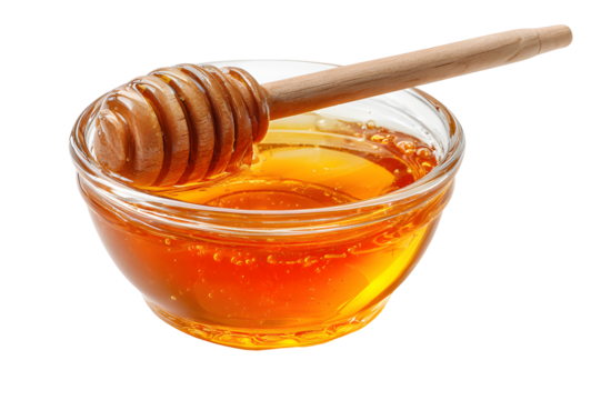Golden honey in a glass bowl with a wooden honey dipper
