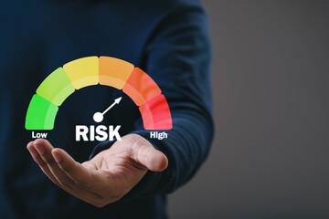 Hand presenting a colorful risk level gauge from low to high, symbolizing business risk assessment, financial decision-making, strategy planning, and evaluation in a modern corporate environment.