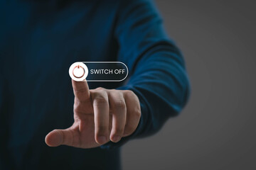 Hand pressing digital switch off button, symbolizing power control, shutdown action, technology interface, energy saving, workflow pause, and digital decision-making in a modern tech environment.