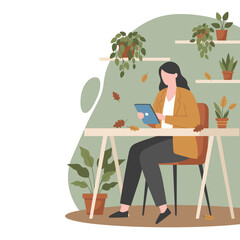 Professional woman using a digital tablet at a desk surrounded by plants and autumn leaves Remote work