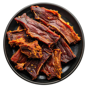 A close-up on chargue de llama highlighting the dried meat's texture and strips isolated on white background