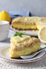 Homemade shortbread pie with lemon-curd filling with cut-off piece in the foreground