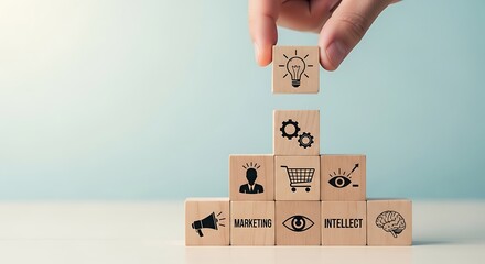 Hand placing wooden block with light bulb icon on top of pyramid of blocks representing business ideas and intellect