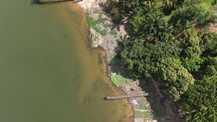 Wooden pier on a riverbank on a sunny day in Brazil.