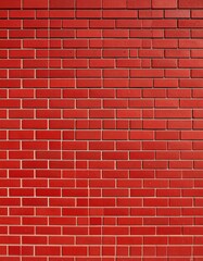 Fototapeta premium The vibrant red brick wall displays a striking pattern of horizontal rows and vertical columns under bright sunlight, creating a visually appealing facade texture.
