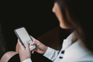 Teen girl typing message on smartphone, fingers in motion over keyboard in real-time communication, highlighting connected and digital-first generation.