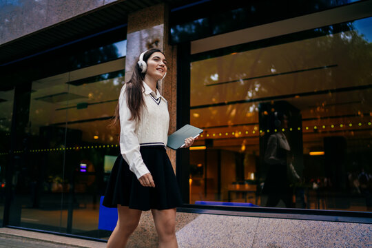Young woman looking at tablet and holding card, concept of identity verification and online access, symbolizing modern digital authentication and personal financial interaction.