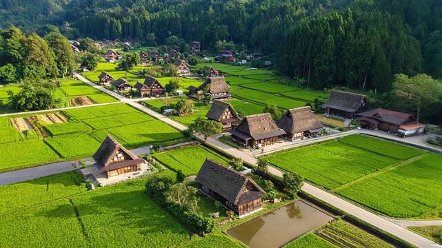 山あいの村に続く田園を空撮で眺めた懐かしい日本の風景