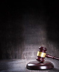 Wooden judge gavel closeup on rustic background with copy space