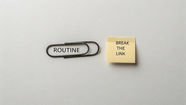Twisted paperclip next to sticky note about breaking routines