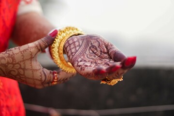 Traditional Bengali bridal hand decorated with mehendi during wedding rituals