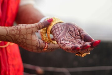 Bengali bridal mehndi hand with traditional gold bangles