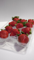 Strawberries in a plastic container on a white background. strawberries isolated.