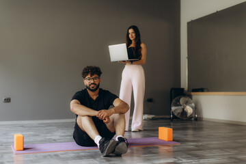 Man and woman learning fitness online