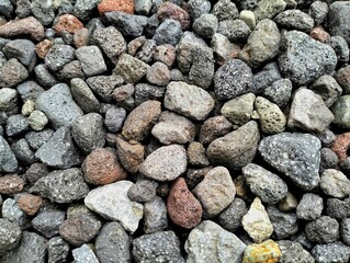 close-up, high-angle view of a heap of mixed river pebbles and crushed volcanic rock