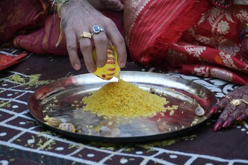 Traditional Bengali Hindu wedding ceremony with turmeric rice offering