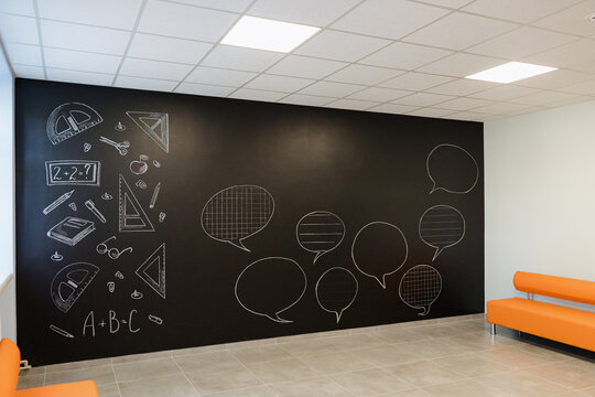Creative learning space with chalkboard wall and vibrant seating area for discussions