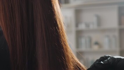 hair shine inspection, stylist assesses glossy hair quality, exquisite salon evaluation of luminous hair strands, professional examination emphasizing radiant hair and seasoned stylist expertise