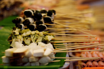 Thai-Asian style barbecue meatballs called 'Mala' served with a rich chili sauce, sold as street food.
