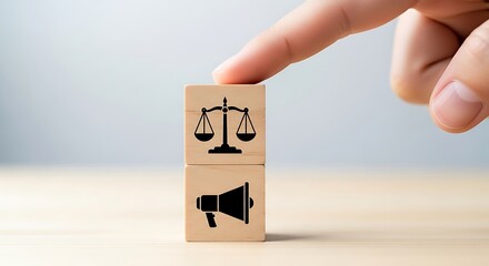 Promoting justice and fairness a hand pushes a block with scales and megaphone symbols for legal advocacy and fair representation