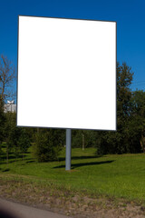 Background for design, white billboards on city streets and along roads in the summer day