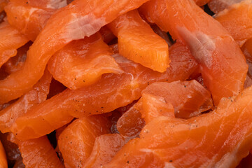 Lightly salted salmon texture background. Sliced salmon