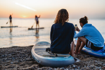 Two people enjoying a calm sunset together, capturing an authentic travel vibe filled with warmth