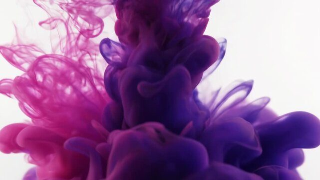 Extreme macro close-up of vibrant pink and indigo ink swirling slowly in clear liquid creating an ethereal abstract cloud formation organic movement, smooth, visual effect
