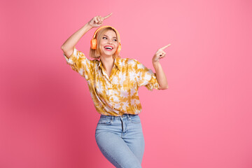 Young woman blonde bob wear yellow shirt dancing headphones pink background looking stylish glamorous lifestyle fashion advertising shopping