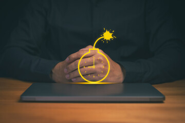 Burnout person sitting with hands clasped over a closed laptop, featuring a time bomb icon symbolizing pressure, deadline stress, urgent risk, business crisis, and critical time management challenges.