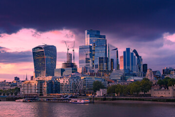 London city skyscrapers by the Thames. Modern skyscrapers rise against with sunset in London City,...