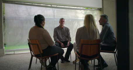 Middle aged man delivering heartfelt confession in therapy circle, emotional breakthrough shared...