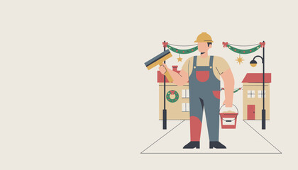 Worker in hard hat installing festive Christmas decorations on a street with houses