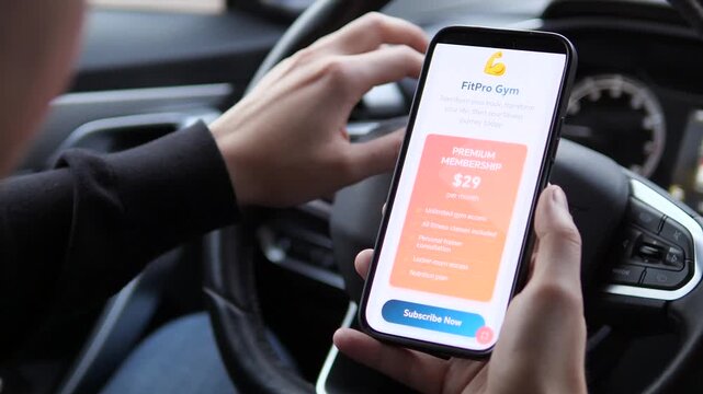Closeup of a mans hands in a parked car, contemplating a gym membership offer on his smartphone. His thoughtful gesture of touching the steering wheel adds a layer of personal reflection, capturing