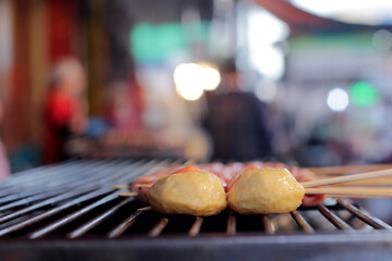 Thai-Asian style barbecue meatballs called 'Mala' served with a rich chili sauce, sold as street food.